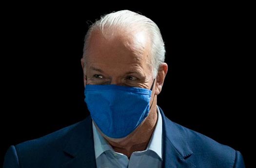 NDP Premier John Horgan wears a mask while campaigning in the 2020 British Columbia election