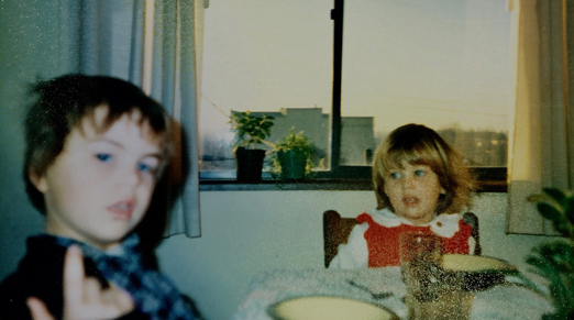 Jude and Megan Tomlin, aged 3 and 16 months, sitting at the kitchen table in 1978