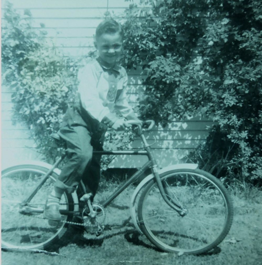 Raymond Tomlin on his bike, spring 1957, at 2165 East 2nd Avenue, in Vancouver