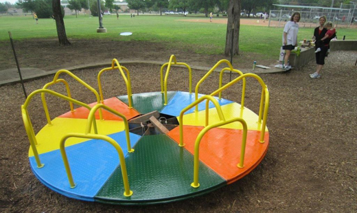 A roundabout, a sort of self-propelled merry-go-round you used to find on many playgrounds