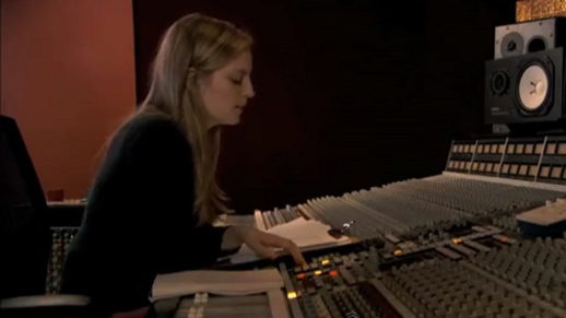 Sarah Polley sitting at the controls recording her father's narrative, in Stories We Tell