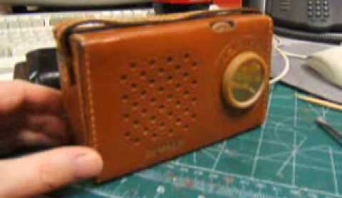1957. Transistor radio and leather case.
